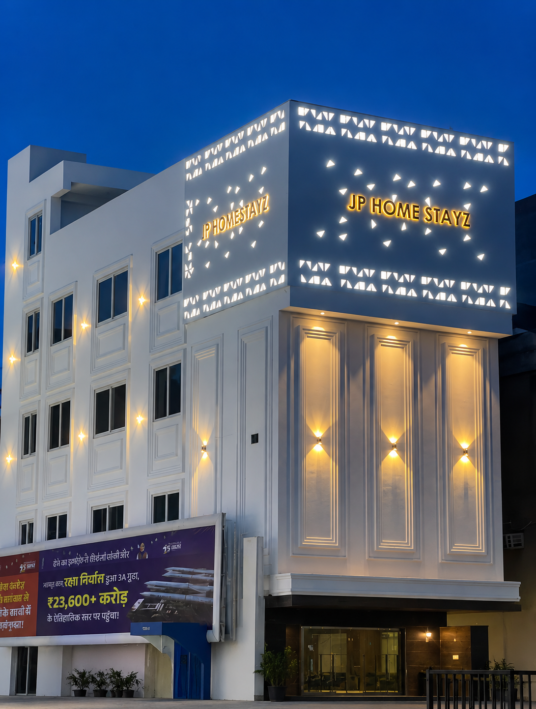 JP Homestayz building — night view at Ashram Chowk, New Delhi